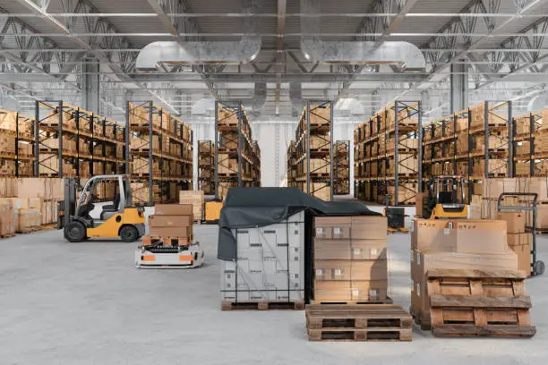 Large warehouse with pallet racking systems, forklifts moving pallets, and efficient storage layout